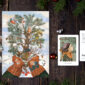 Postcard on a Christmas theme on a wooden table with a Christmas tree and decorations